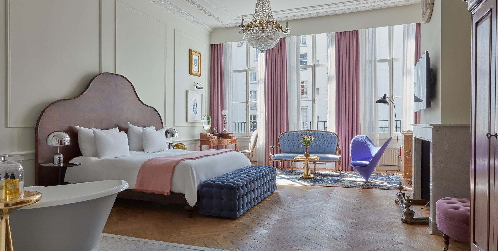 A refined suite featuring classic decor, comfortable seating, and tasteful artwork.