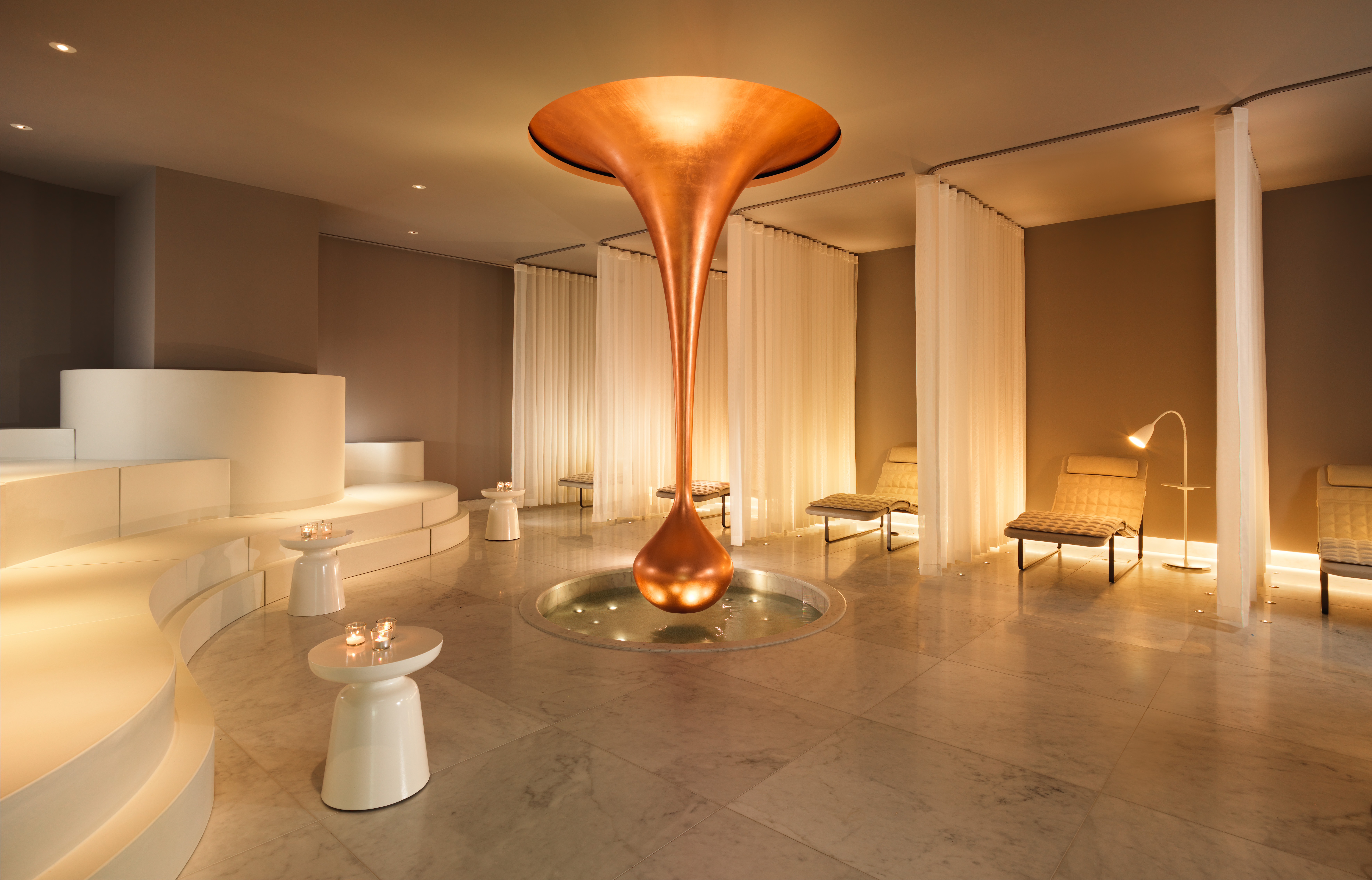 Spa area with a tranquil atmosphere, featuring massage tables and relaxing ambient lighting.