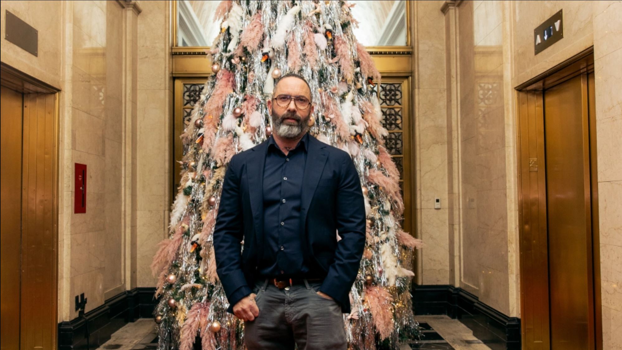 A portrait of Alexis, smiling warmly in an elegant setting, with soft lighting creating a pleasant atmosphere.