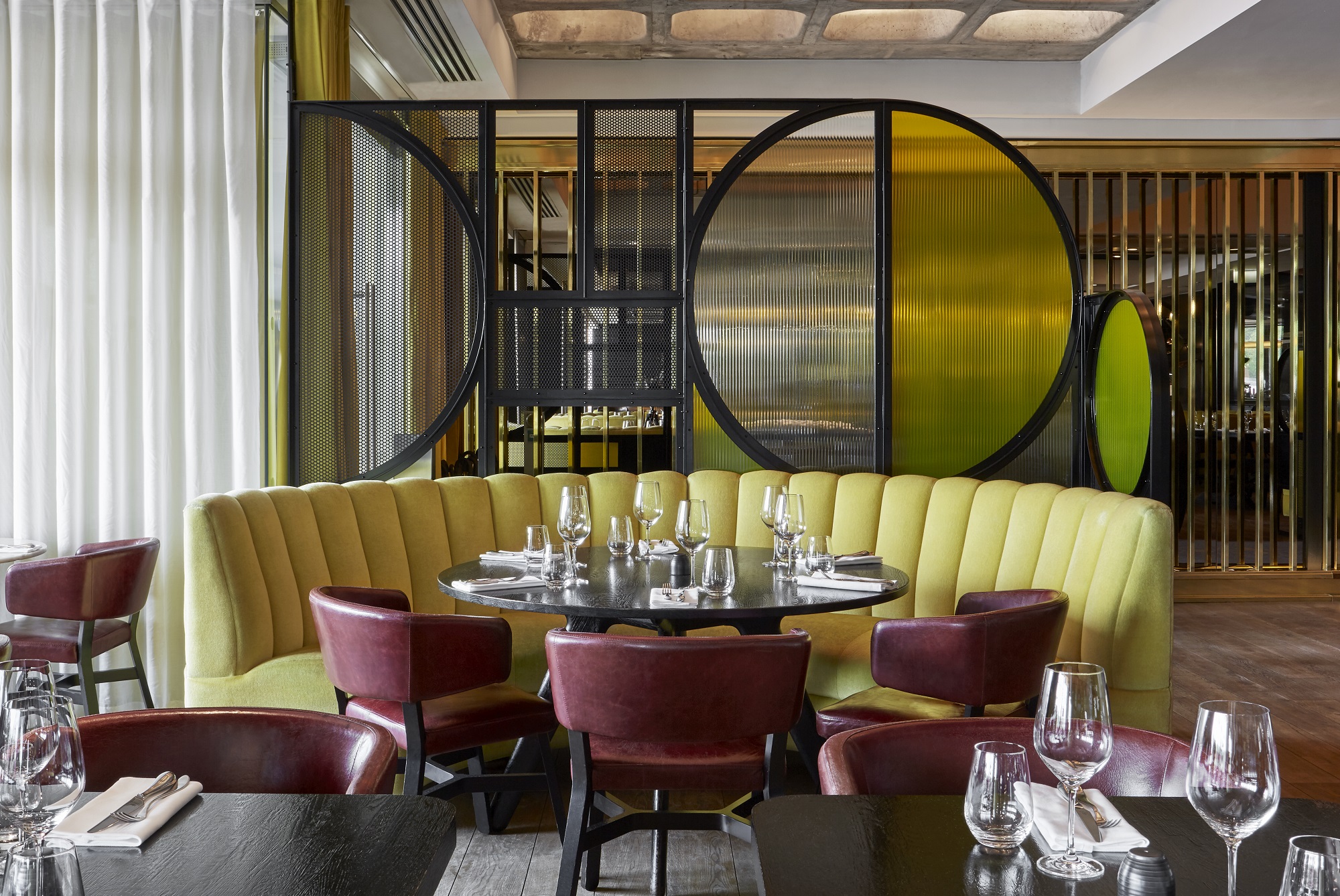 Restaurant interior at Sea Containers London with elegant dining tables, ambient lighting, and a welcoming atmosphere.