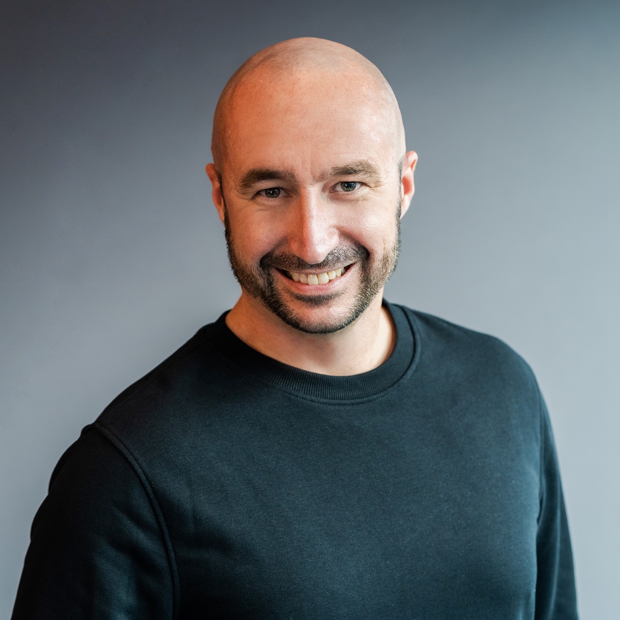 Professional headshot of Jon Dawson, CPO at Lore Group hotel and restaurant group.