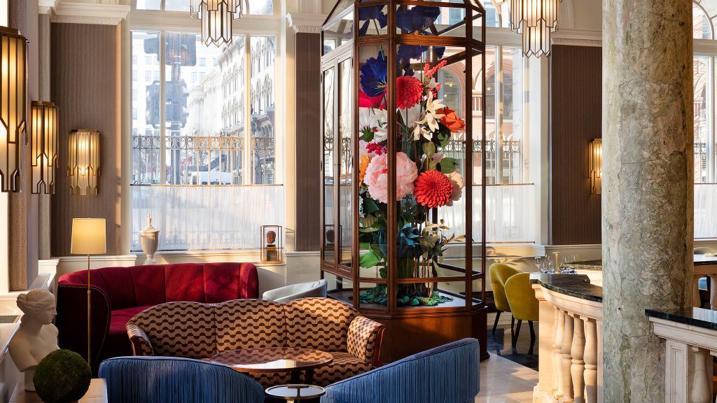 Gorgeous flower column at Riggs Washington DC surrounded by colorful furniture and large windows.