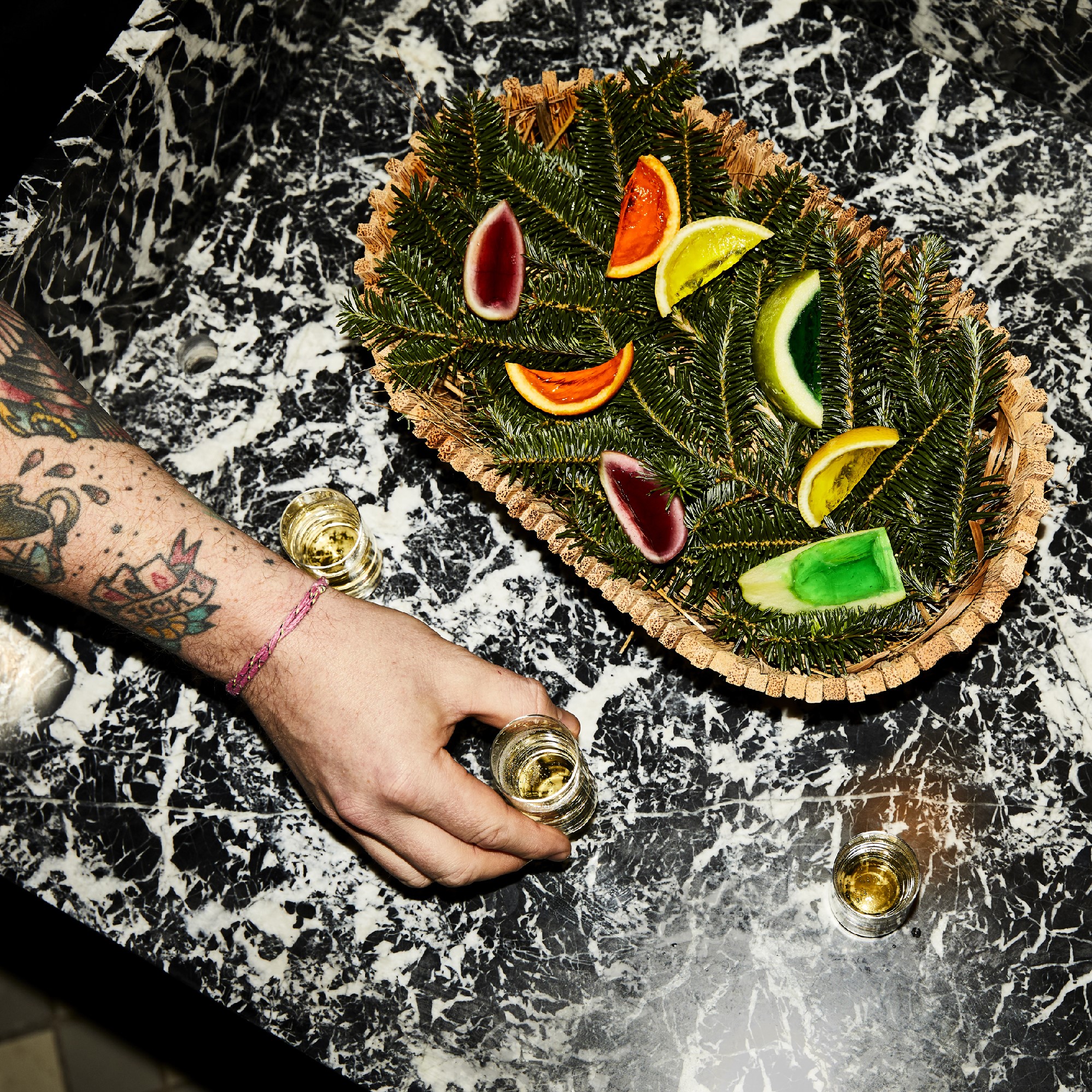 Close-up of a colorful jello fruit basket, artistically arranged in basket with pine decoration.