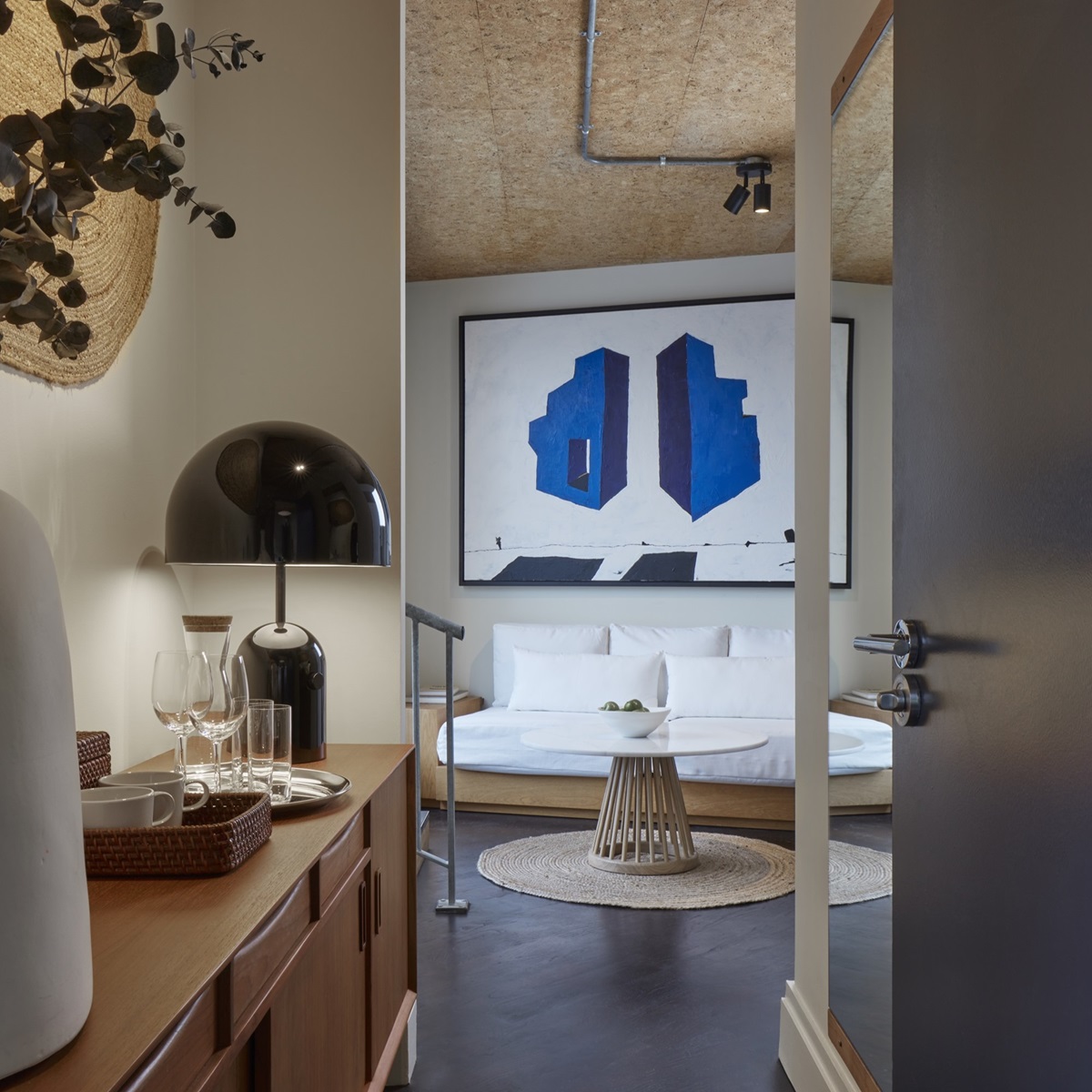 Cool and unique hotel room interior at OHS in London with modern artwork and natural furnishing.